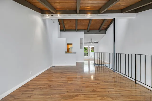 a view of entryway and hall with a wooden floor