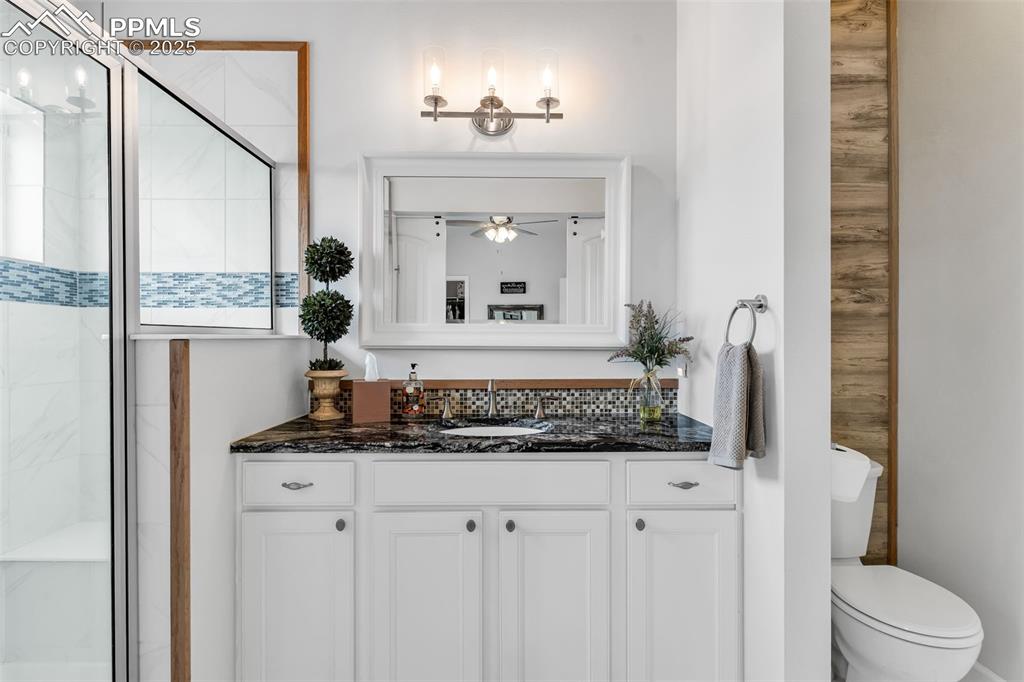 10380 Coyote Lane Rye, CO 81069 - Photo 20 of 50 a bathroom with a granite countertop sink and a mirror