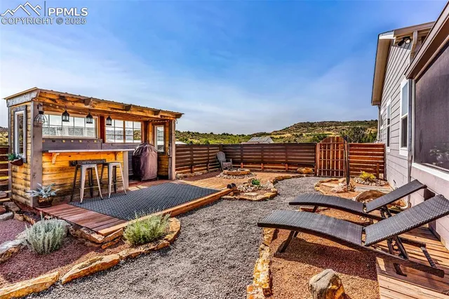 a view of a balcony with chairs and wooden floor