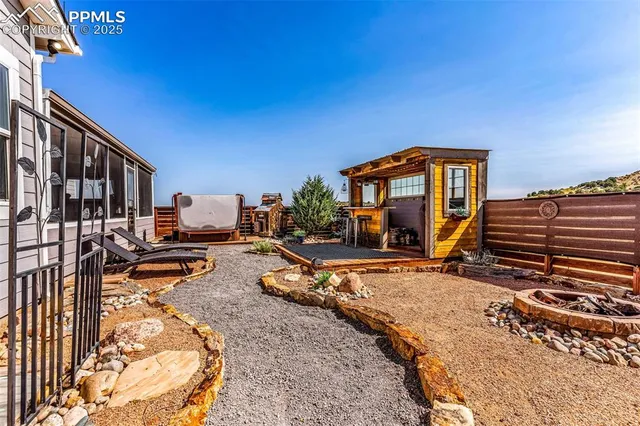 a view of a house with backyard porch and sitting area