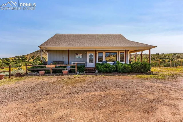 a backyard of a house with yard table and chairs
