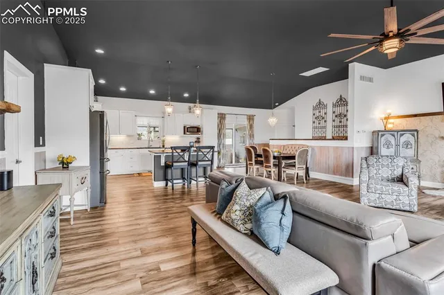 a living room with lots of furniture and kitchen view