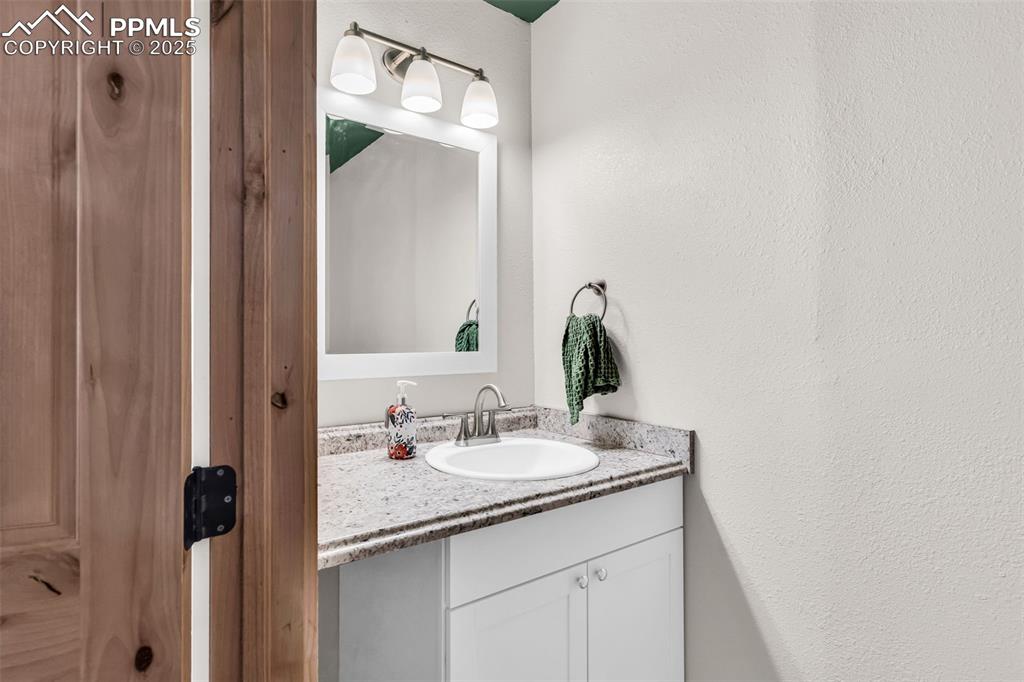 10380 Coyote Lane Rye, CO 81069 - Photo 43 of 50 a bathroom with a granite countertop sink and a mirror
