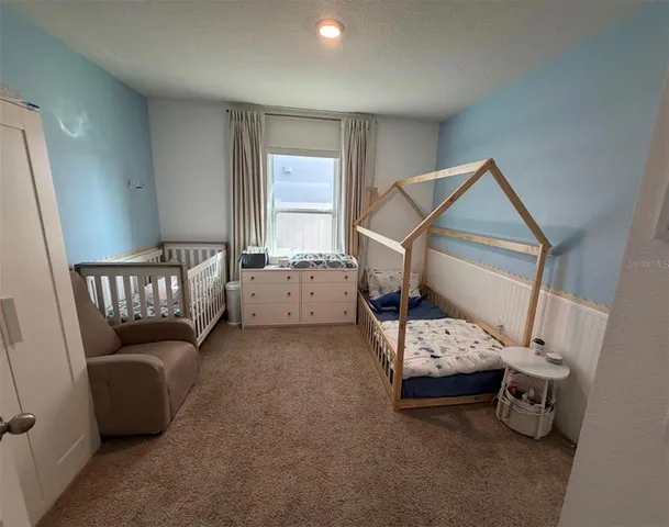 a bedroom with furniture and a window