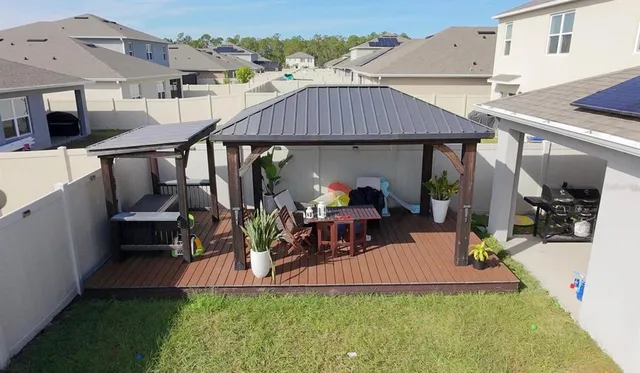 an outdoor space with seating area and hardwood floor