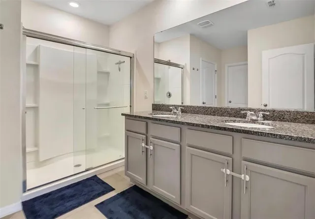 a bathroom with a granite countertop sink mirror and a