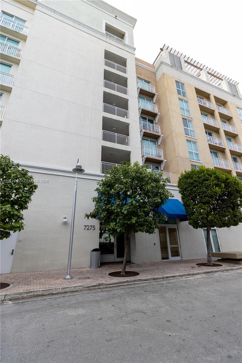 7275 Southwest 90th Way, Unit 213 Miami, FL 33156 - Photo 3 of 31 a potted plant sitting in front of a building