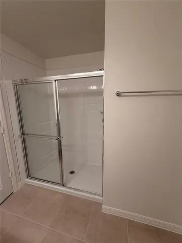 a bathroom with a glass door shower