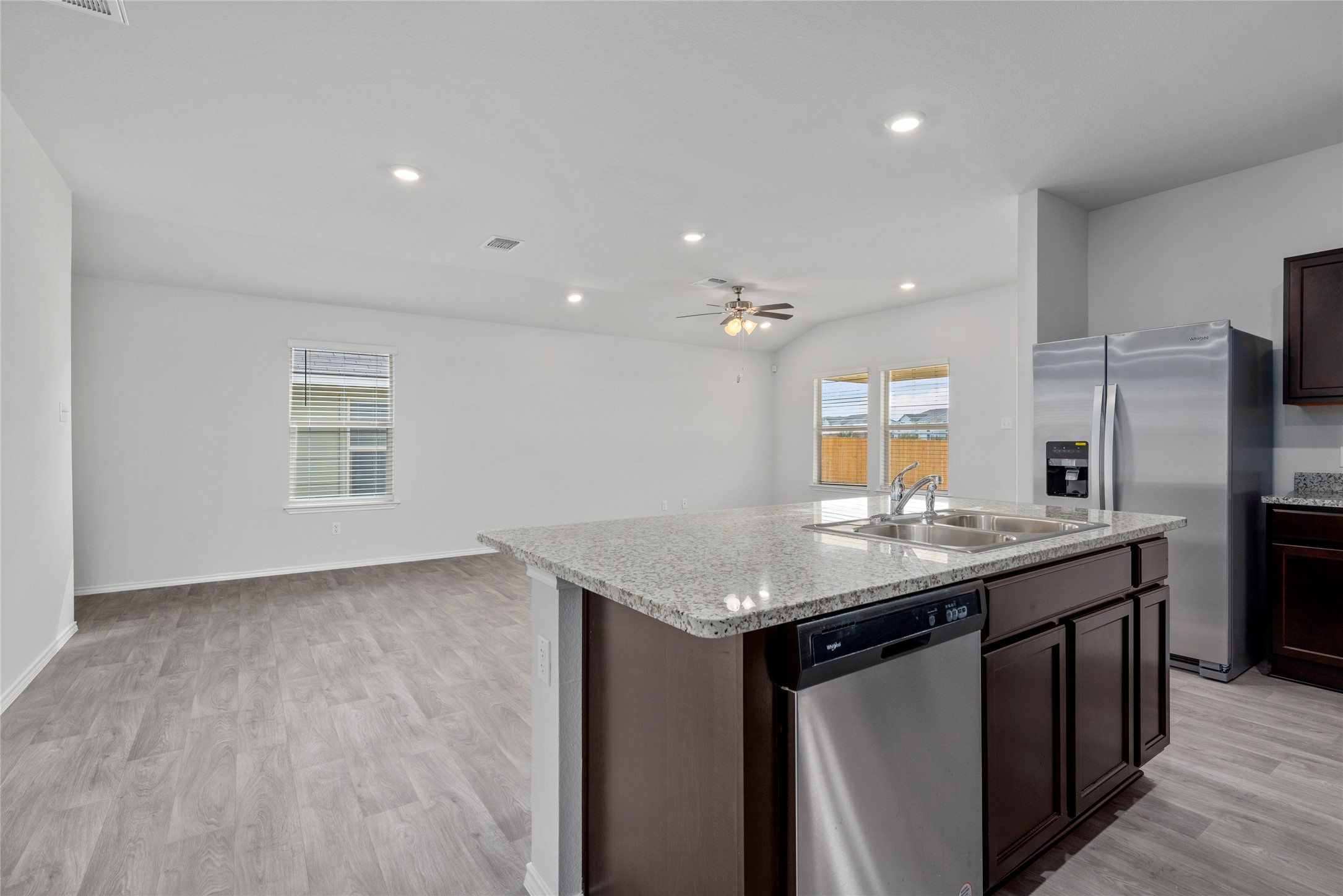 1417 Victory Rnch Trail Killeen, TX 76549 - Photo 2 of 22 A pristine open-concept living space features a spacious kitchen island with a double basin sink and stainless steel appliances.