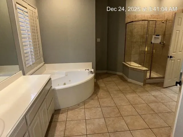 a bathroom with a bathtub and shower