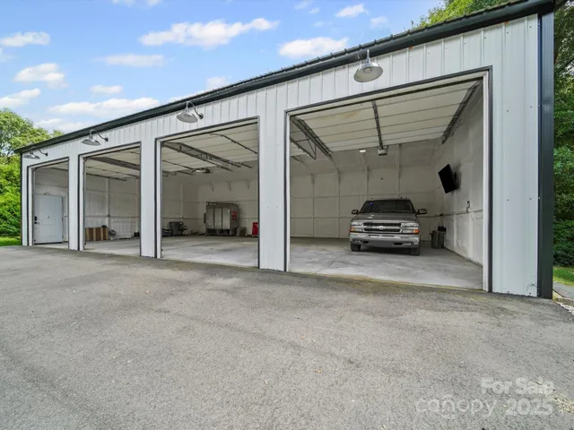 a view of a car garage with a car parked in front of it