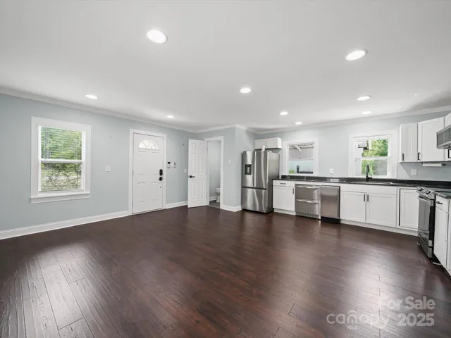 a view of kitchen with cabinets and wooden floor