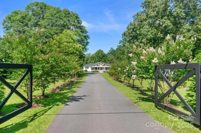 a view of a pathway both side of flower yard