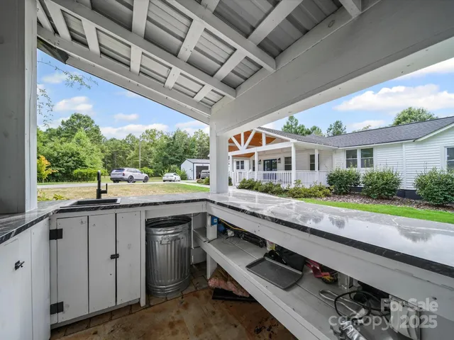 a kitchen with stainless steel appliances granite countertop a sink and cabinets