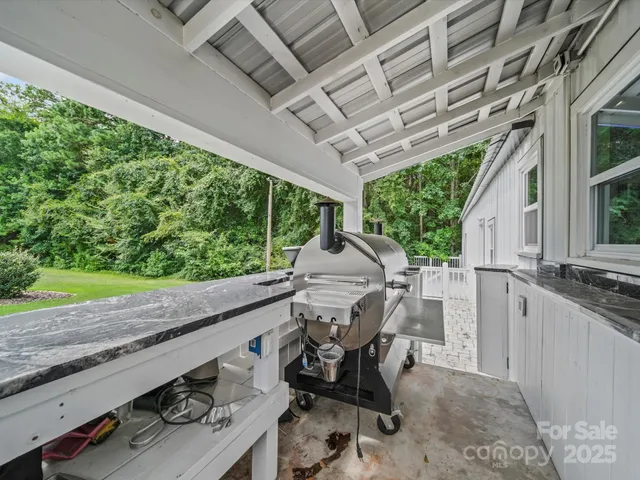 a view of a patio with table and chairs with wooden floor and fence