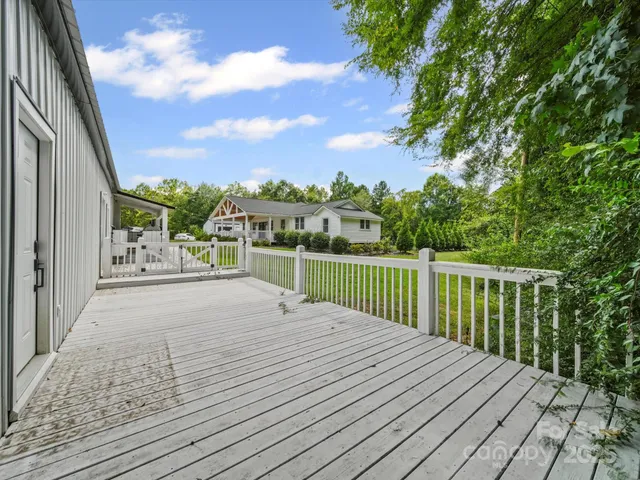 a view of balcony with wooden floor and fence