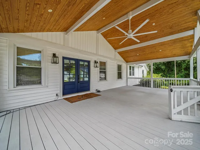 a view of a porch with wooden floor and fence