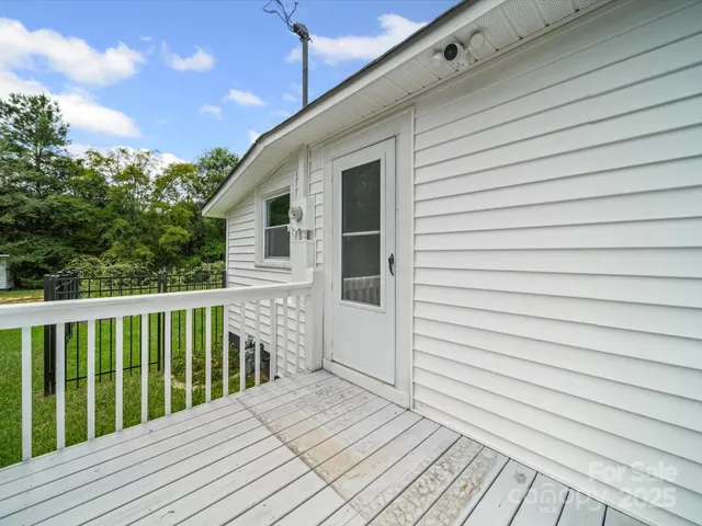 a balcony with wooden floor and fence