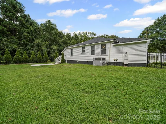 a view of a house with a yard and sitting area
