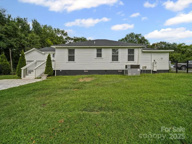 a backyard of a house with table and chairs