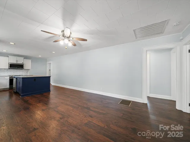 a view of kitchen with sink and wooden floor