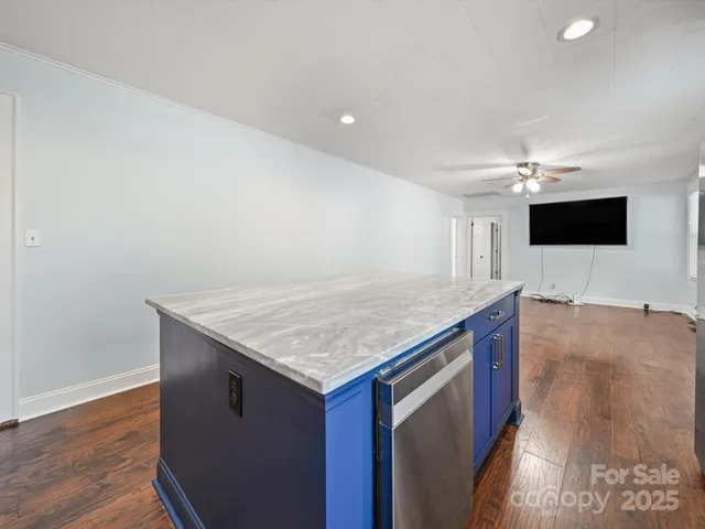 a kitchen with stainless steel appliances granite countertop a sink and a stove