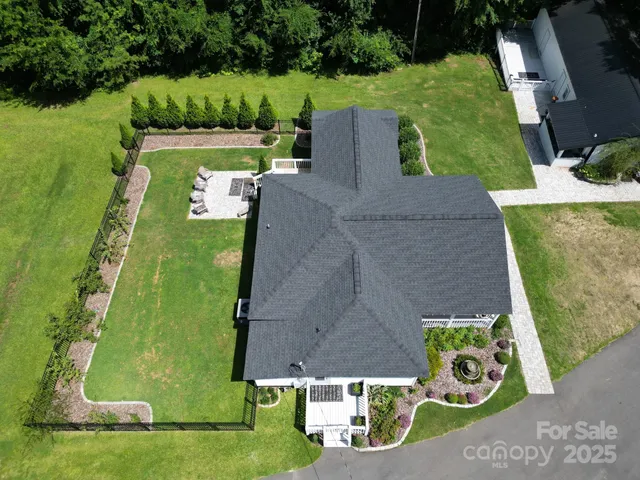 an aerial view of a house with a yard