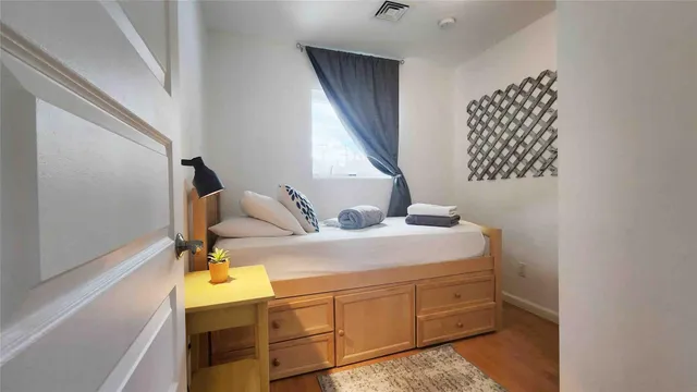 a bedroom with a bed and a window