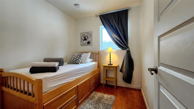 a bedroom with bed and a chandelier