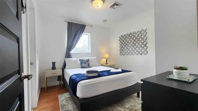 a bedroom with a bed and a window