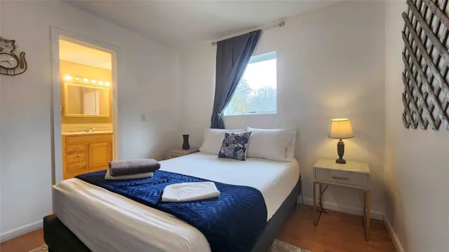 a bedroom with a bed and wooden floor