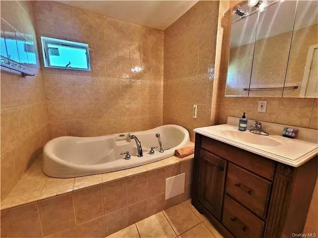 a bathroom with a granite countertop toilet sink and mirror