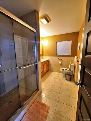 a bathroom with a glass shower door
