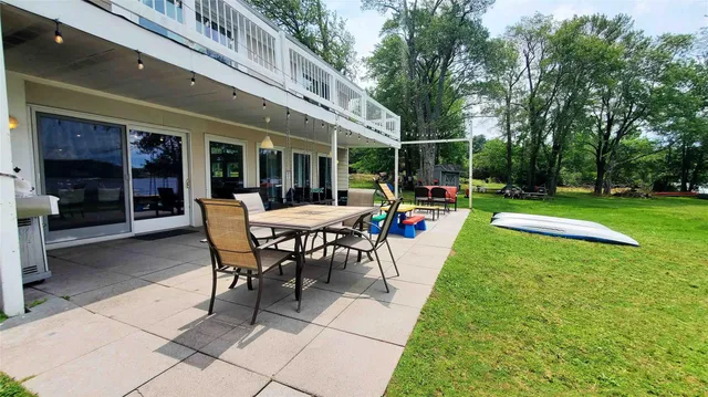 a view of a backyard with garden and patio