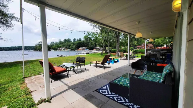a view of a patio with a dining table and chairs with wooden fence