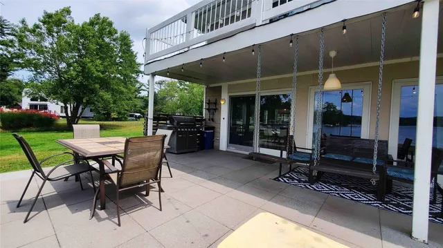 a view of a house with a yard porch and sitting area