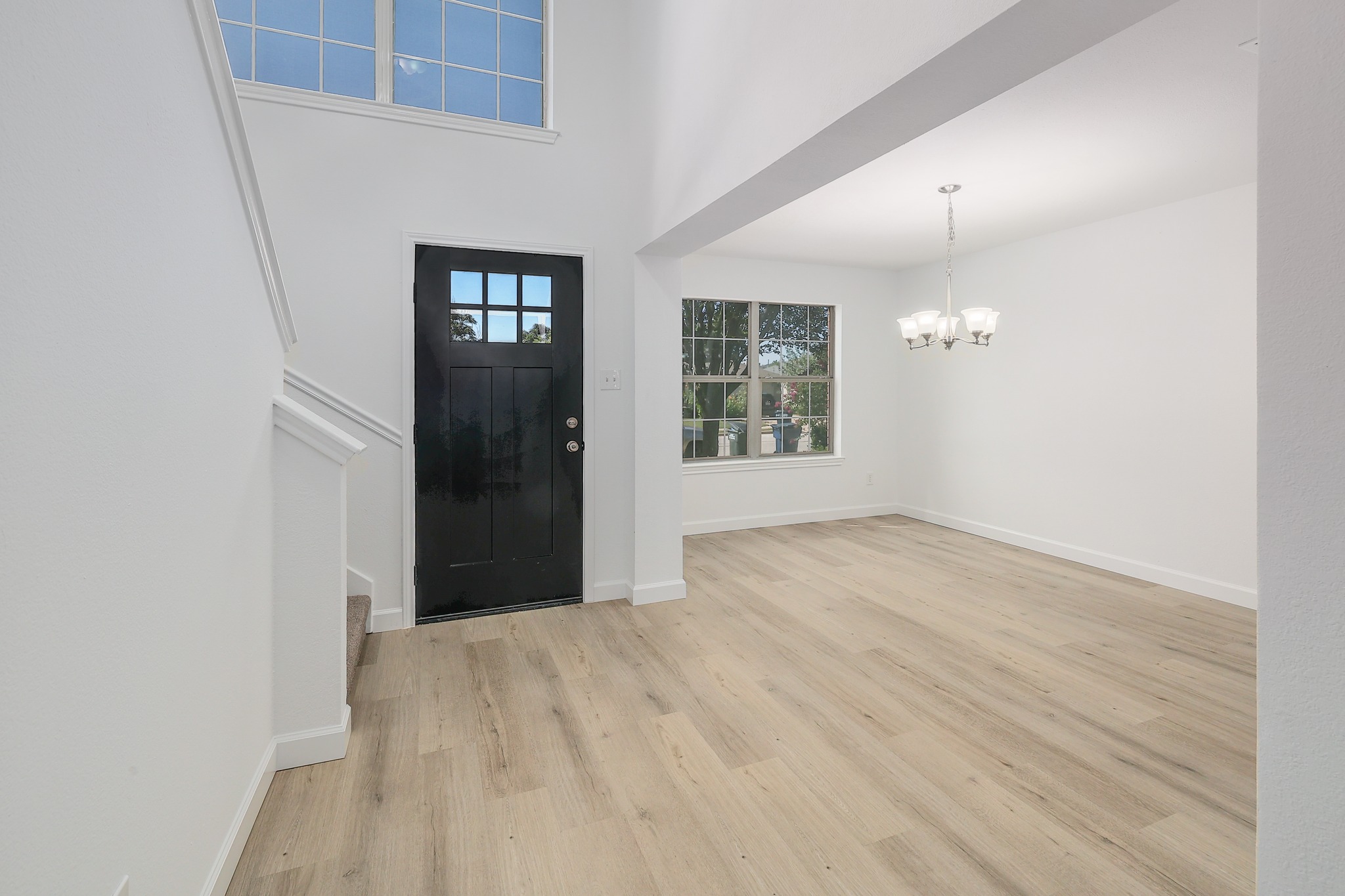 709 Los Robles Road Leander, TX 78641 - Photo 15 of 26 An inviting entry opens to a spacious living area, highlighted by light wood flooring and natural illumination.
