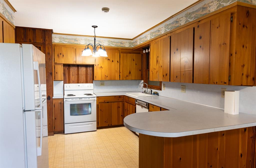 1925 Highway 527 Elm Grove, LA 71051 - Photo 10 of 15 a kitchen with refrigerator a stove a sink and dishwasher with wooden floor