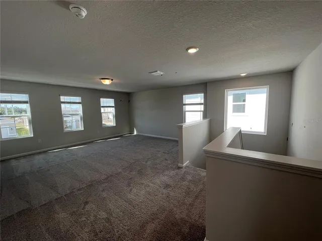 a view of empty room with windows