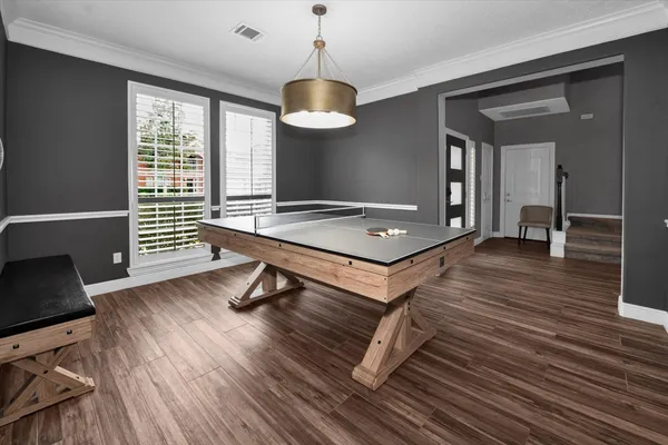 a living room with hard wood floor and a window