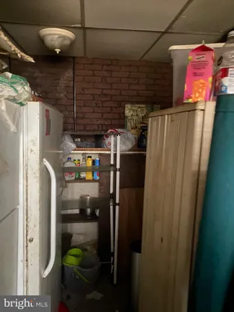 a close up of storage and utility room with refrigerator