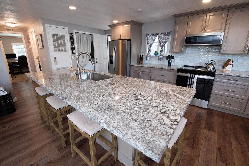 107 Schooner Lane Modesto, CA 95356 - Photo 13 of 43 a kitchen with large counter space and wooden floor