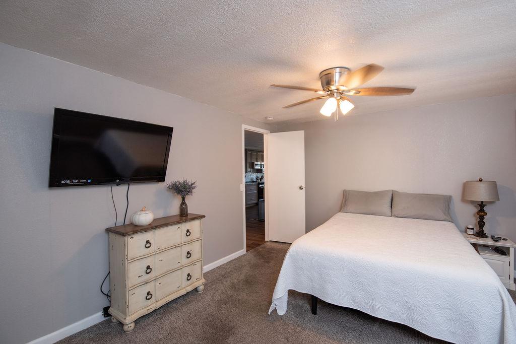 107 Schooner Lane Modesto, CA 95356 - Photo 20 of 43 a bedroom with a bed and a flat screen tv