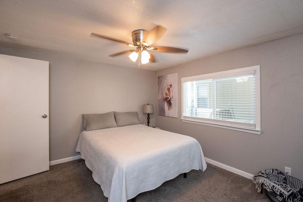 107 Schooner Lane Modesto, CA 95356 - Photo 21 of 43 a bedroom with a bed and a chandelier
