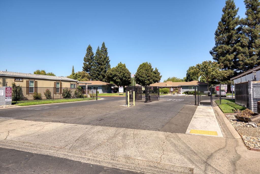 107 Schooner Lane Modesto, CA 95356 - Photo 35 of 43 a view of a white house with large windows next to a road