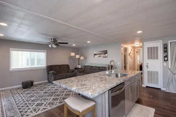 a view of living room with granite countertop furniture and fireplace