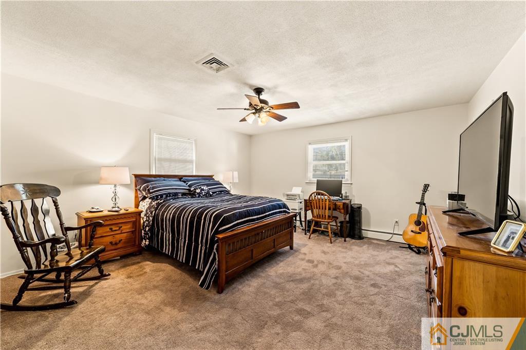39 Landvale Road Spotswood, NJ 08884 - Photo 12 of 34 a bedroom with a bed and a chandelier