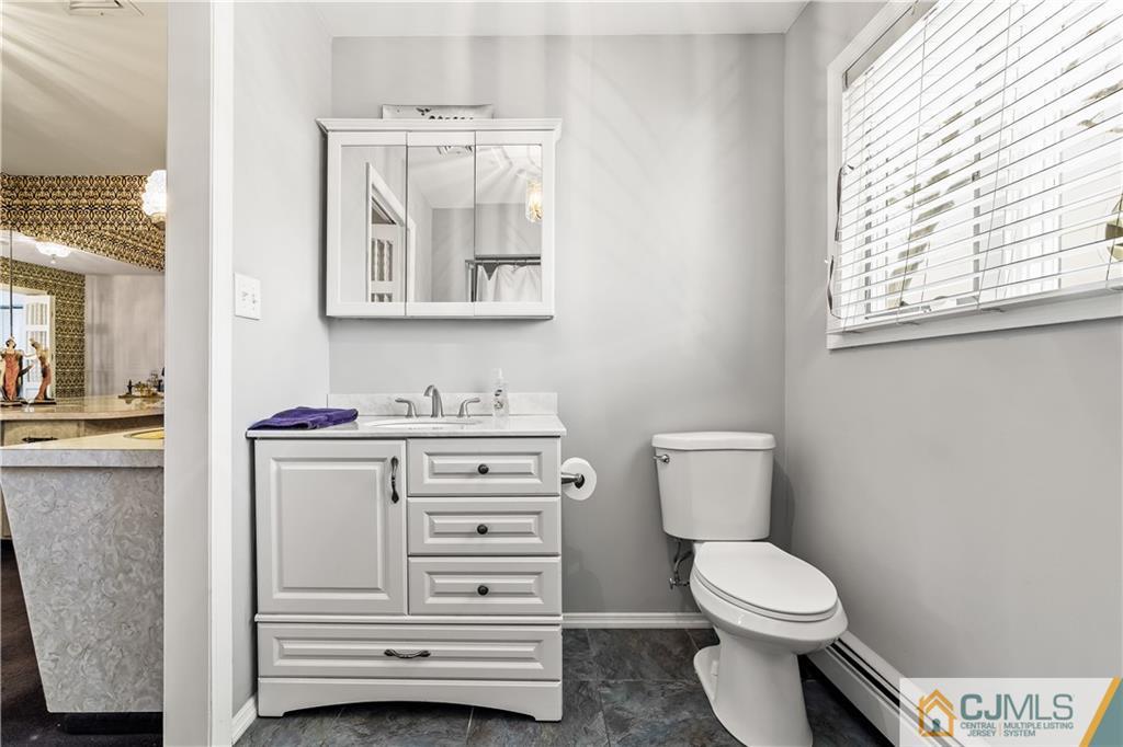 39 Landvale Road Spotswood, NJ 08884 - Photo 15 of 34 a bathroom with a toilet sink and mirror