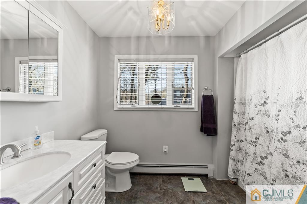 39 Landvale Road Spotswood, NJ 08884 - Photo 16 of 34 a bathroom with a sink a toilet and a window