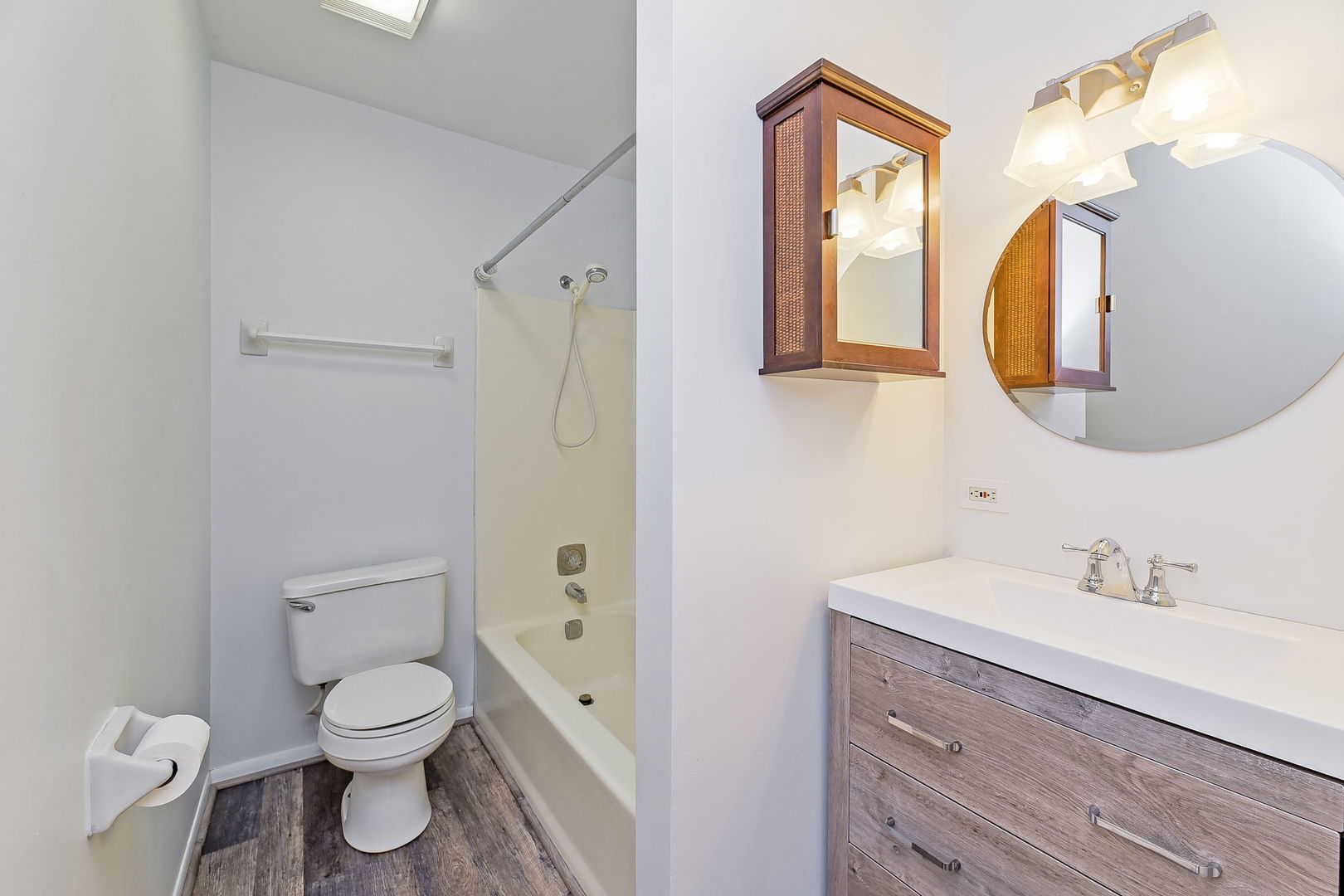 1464 Stonebridge Circle, Unit E3 Wheaton, IL 60189 - Photo 4 of 9 a bathroom with a toilet sink and mirror